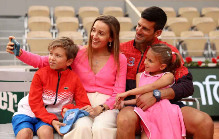 Novak Djokovic poses with the gold medal with his beautiful family